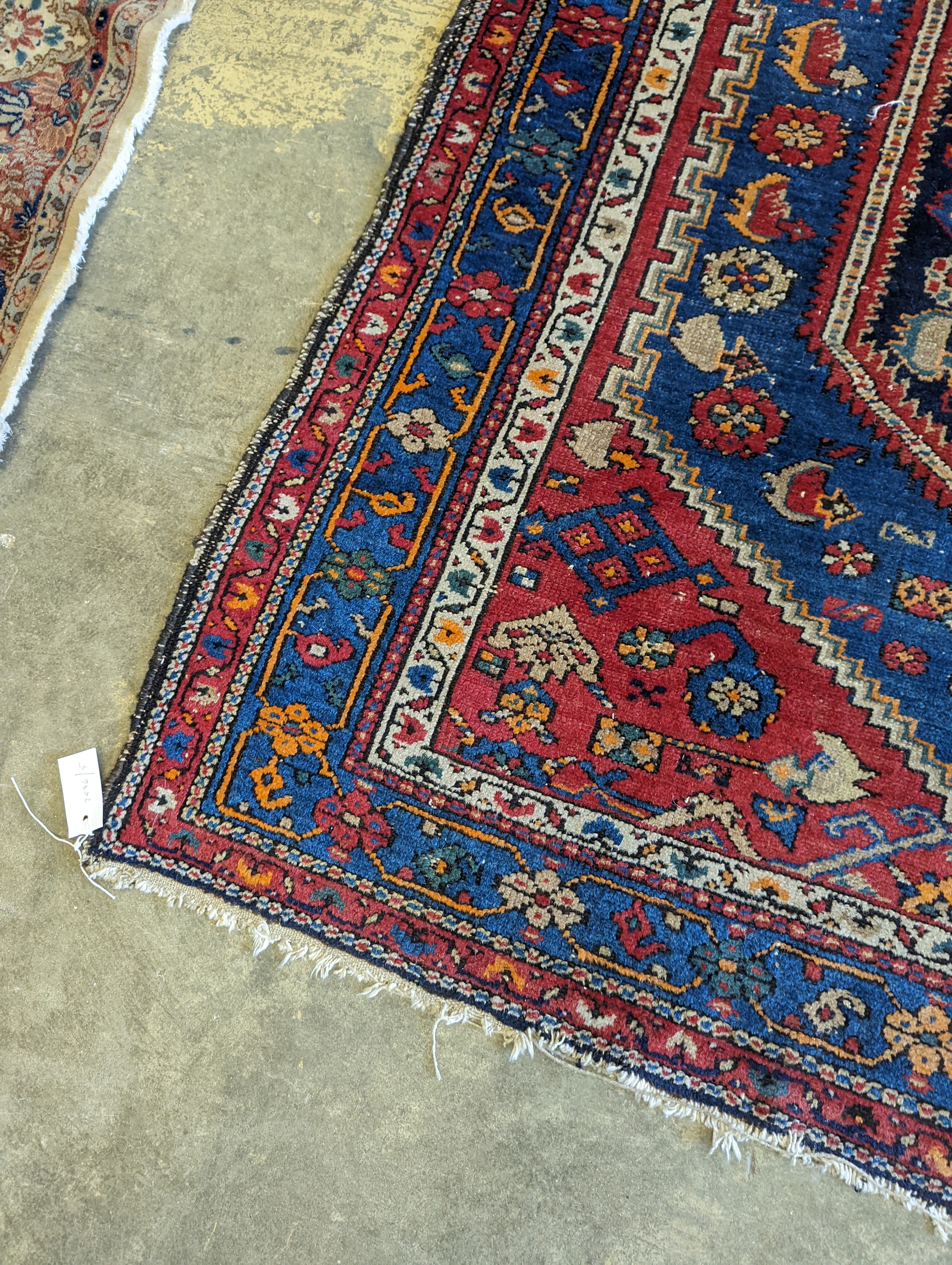 A Caucasian brick red ground rug, 194 x 130cm